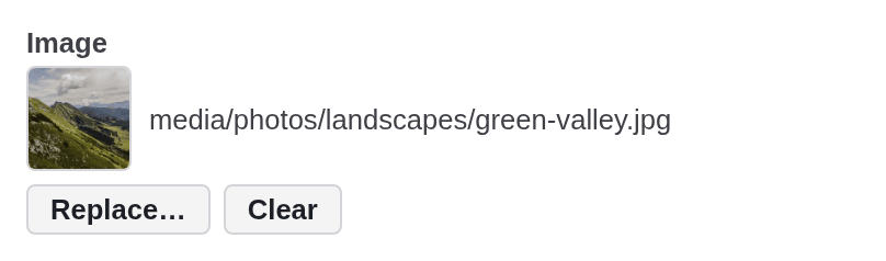 An image field with a thumbnail of a green valley, the reference media/photos/landscapes/green-valley.jpg and the buttons Replace and Clear